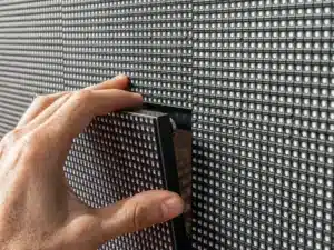 Technician removing an LED video wall panel during installation or maintenance of a modular LED display
